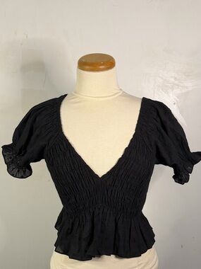 Smocked V-Neck Peplum Blouse in Black